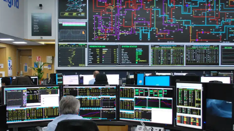 An industrial control room with operators monitoring infrastructure systems.