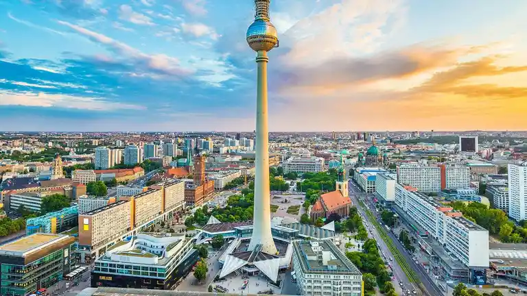 Berlin TV tower rising over the city at sunset