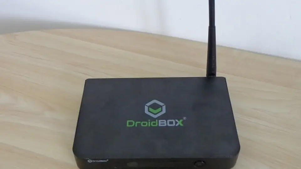 Off-brand Android TV box with antenna on a table