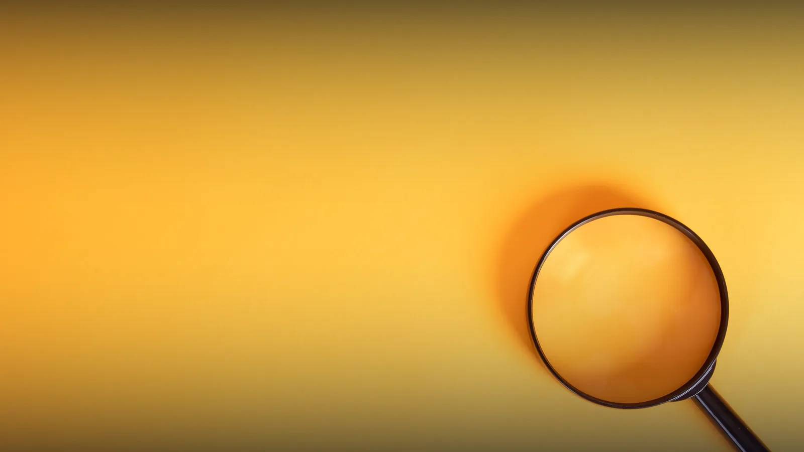 Magnifying glass on a yellow background, representing search