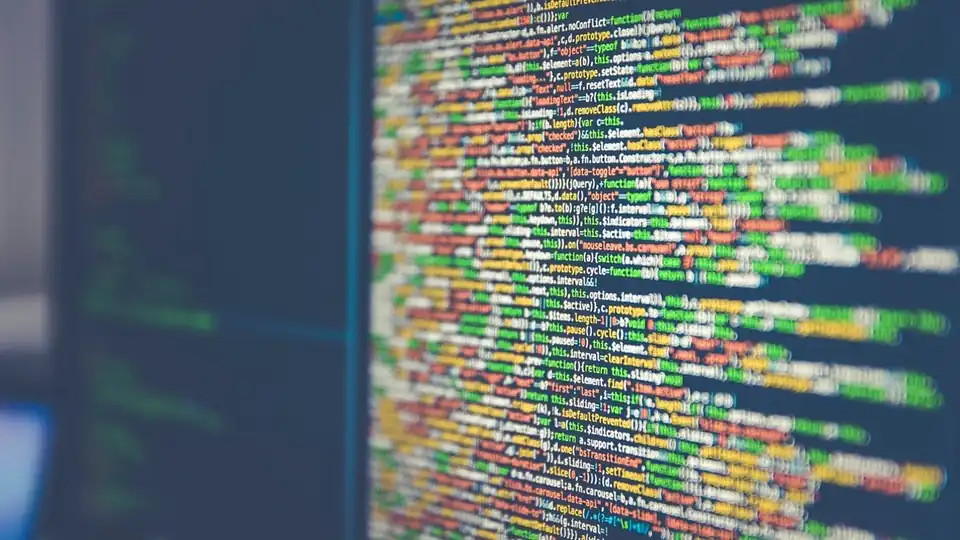 Close-up of dense colorful code on a dark screen