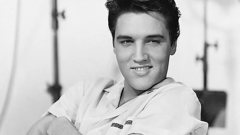Black-and-white studio portrait of Elvis Presley from 1958