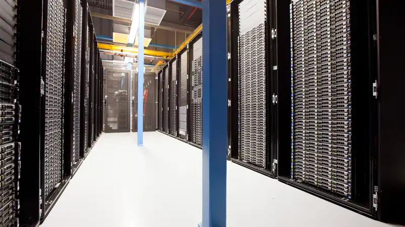 Rows of server racks inside a large data center hall