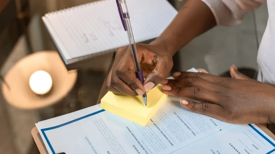 A person filling out a resume on a laptop