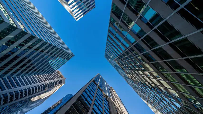 Modern office towers — the commercial insurance industry Mandl says it will rebuild with AI