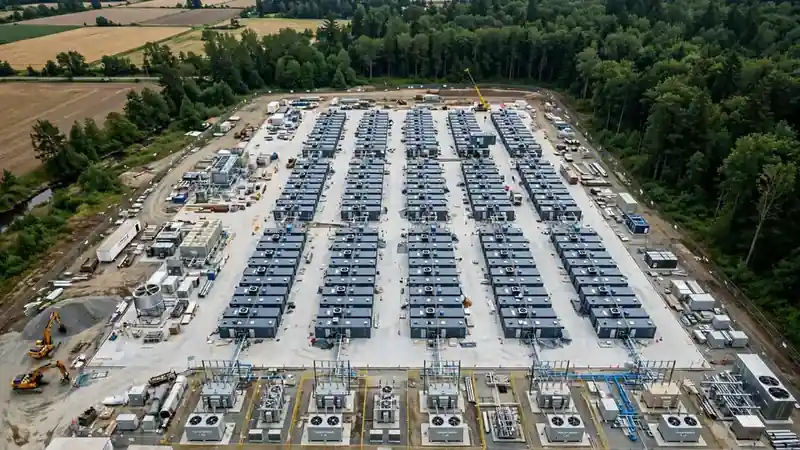 Aerial illustration of modular container AI factory modules arranged at an industrial site