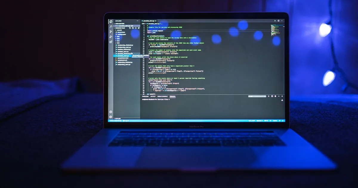 A developer working at a computer with code on the screen, representing OpenAI’s Codex coding agent.