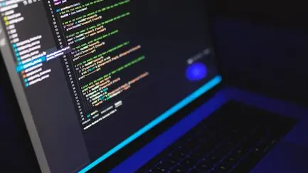 Close-up of a developer’s hands typing code on a laptop keyboard.