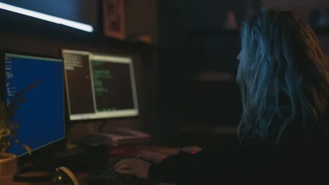 A developer working late at a desk with multiple screens, evoking a daily shipping sprint.