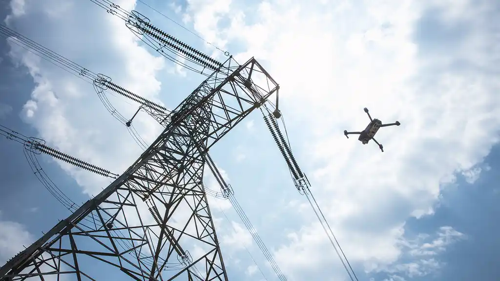 An industrial drone in flight over infrastructure