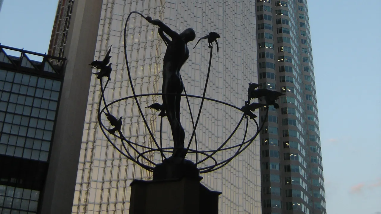 The Royal Bank Plaza tower in Toronto with a sculpture silhouetted in front of it