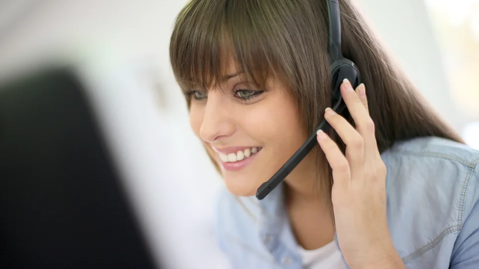 A customer service agent wearing a headset on a call