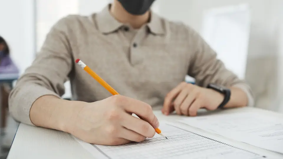 A student writing an exam paper