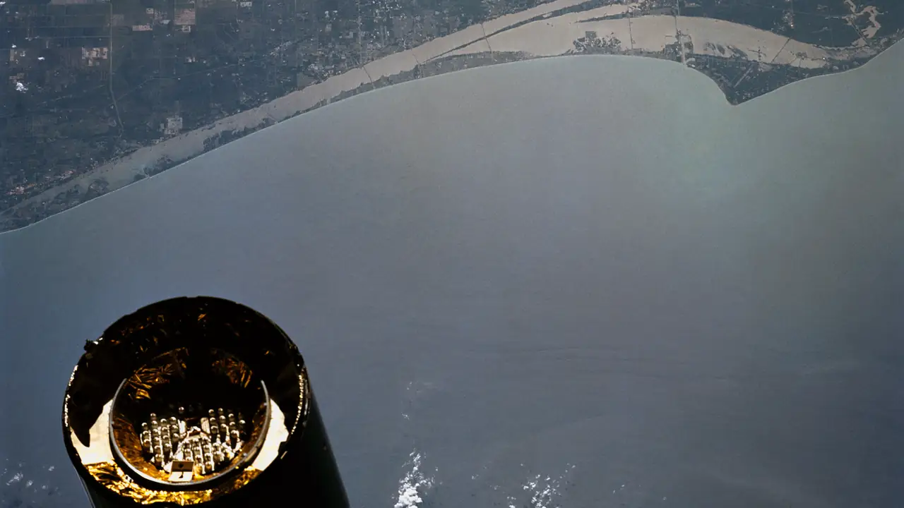Intelsat VI communications satellite drifting over Florida's Kennedy Space Center, seen from orbit