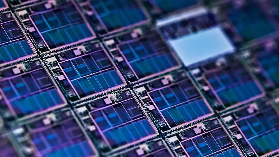 Macro photograph of a processed semiconductor die showing individual chip blocks