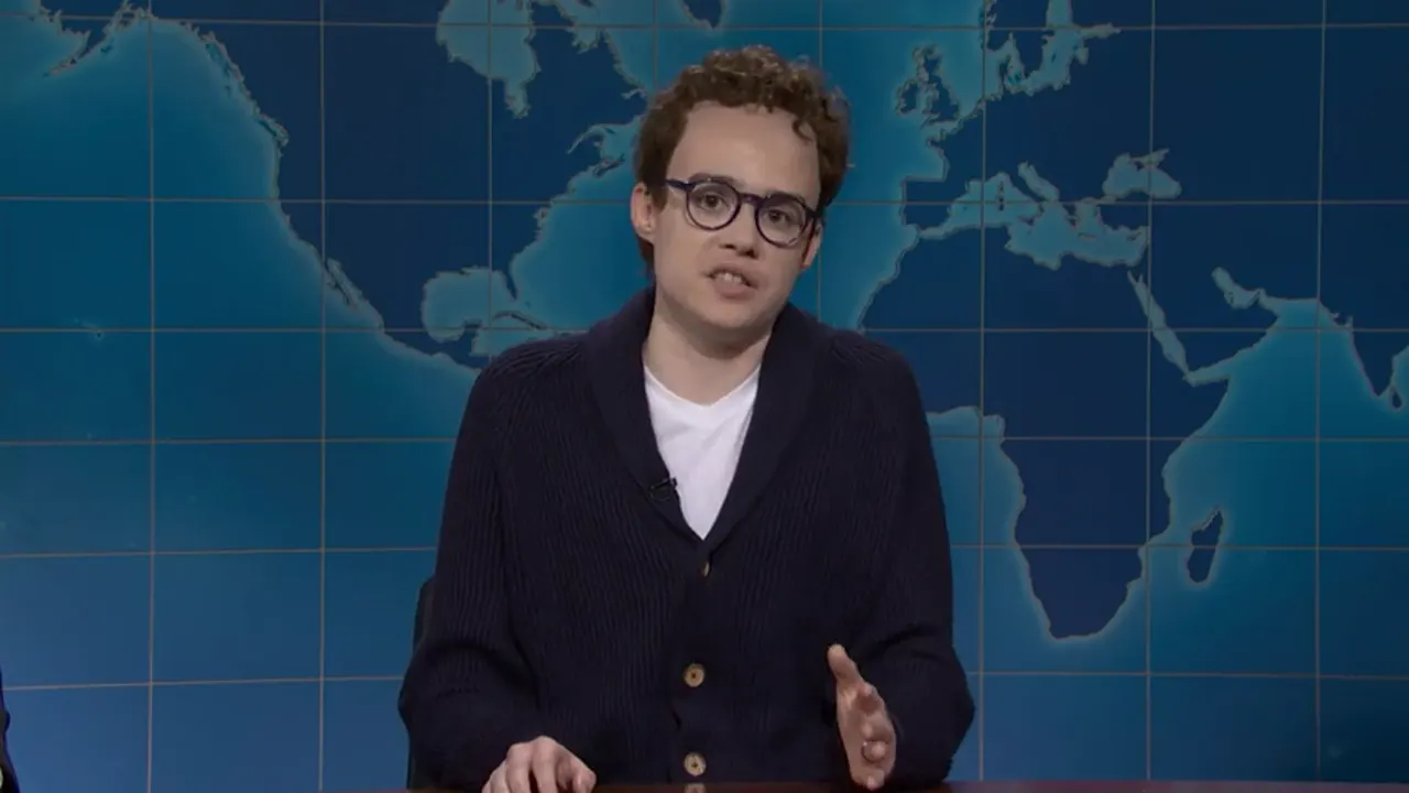 Jane Wickline portraying Anthropic CEO Dario Amodei at the Weekend Update desk on Saturday Night Live