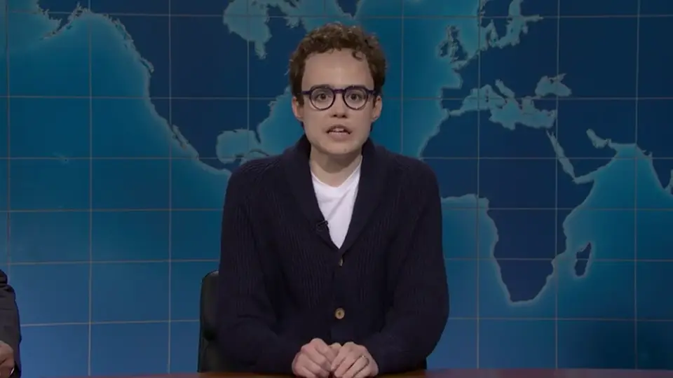 Jane Wickline portraying Anthropic CEO Dario Amodei at the Weekend Update desk on Saturday Night Live
