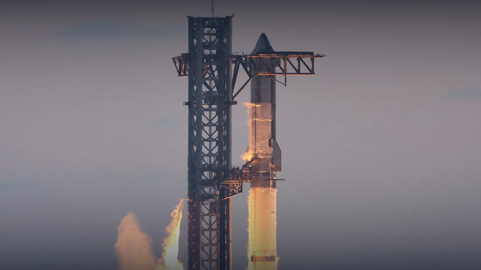 SpaceX Starship on the launch pad with engines igniting