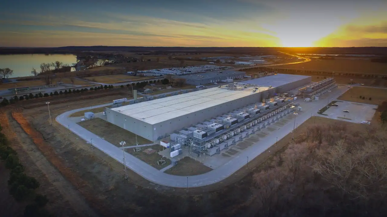 Aerial view of a large AI datacenter campus at sunset
