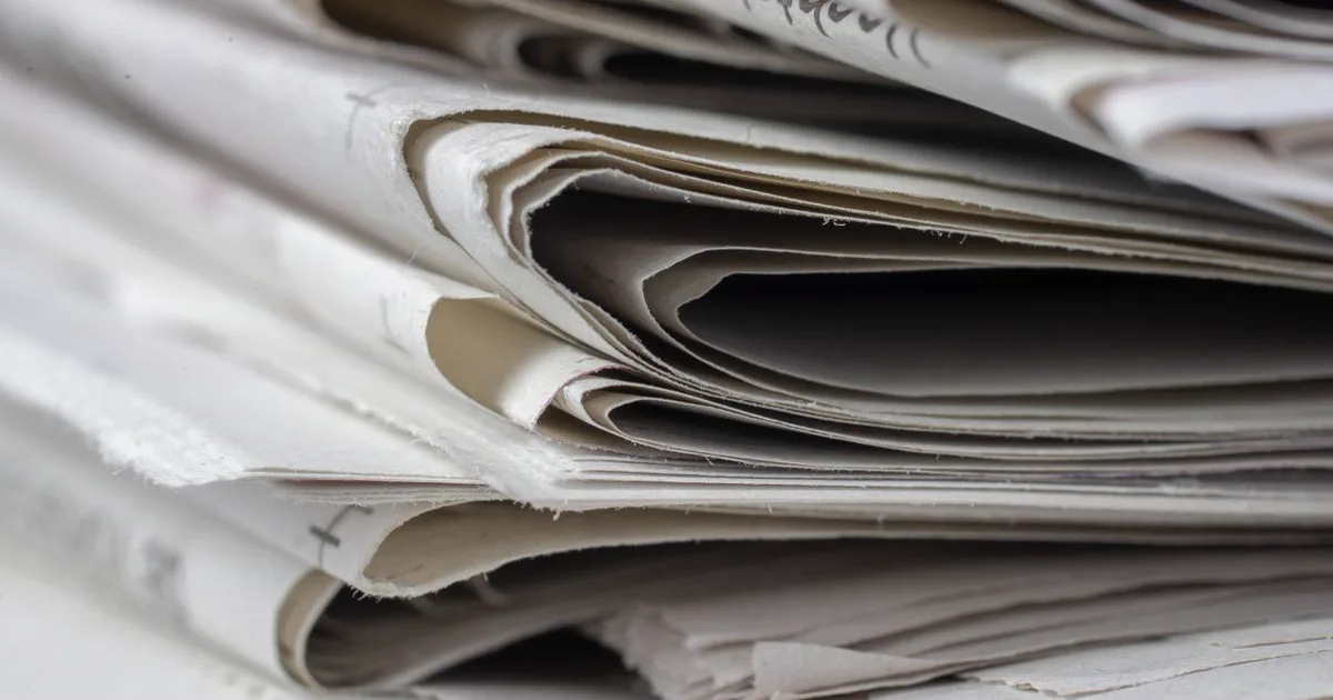 Editorial photo: a stack of folded newspapers