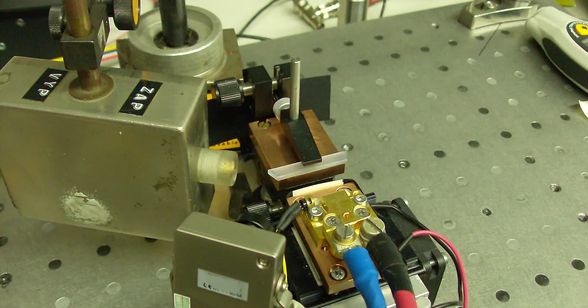 A green laser beam fired through the air in a laboratory