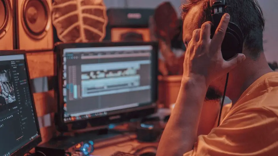 Audio engineer editing sound on a computer in a recording studio